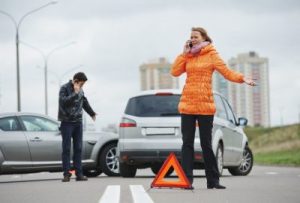 Bărbat și femeie la locul unui accident de mașină