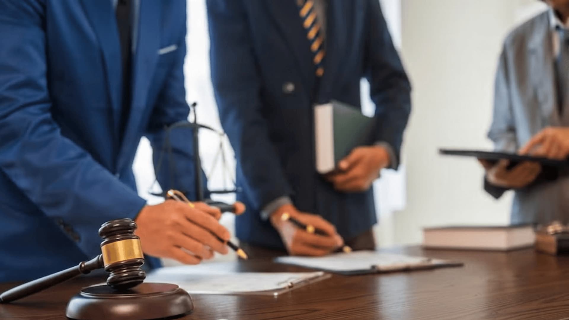 A legal deposition with a gavel and documents on a desk
