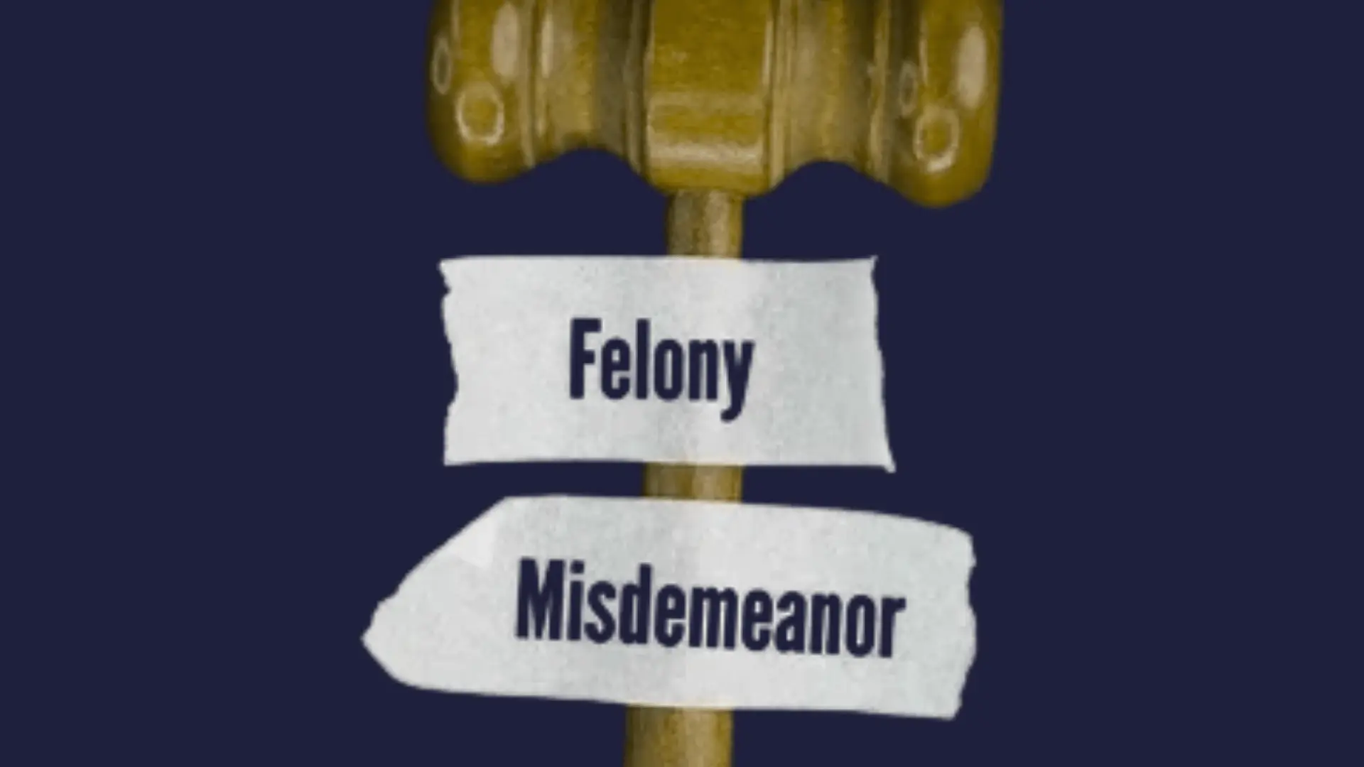 A wooden gavel against a dark blue background with two labels _Felony_ and _Misdemeanor,_ symbolizing legal distinctions and justice