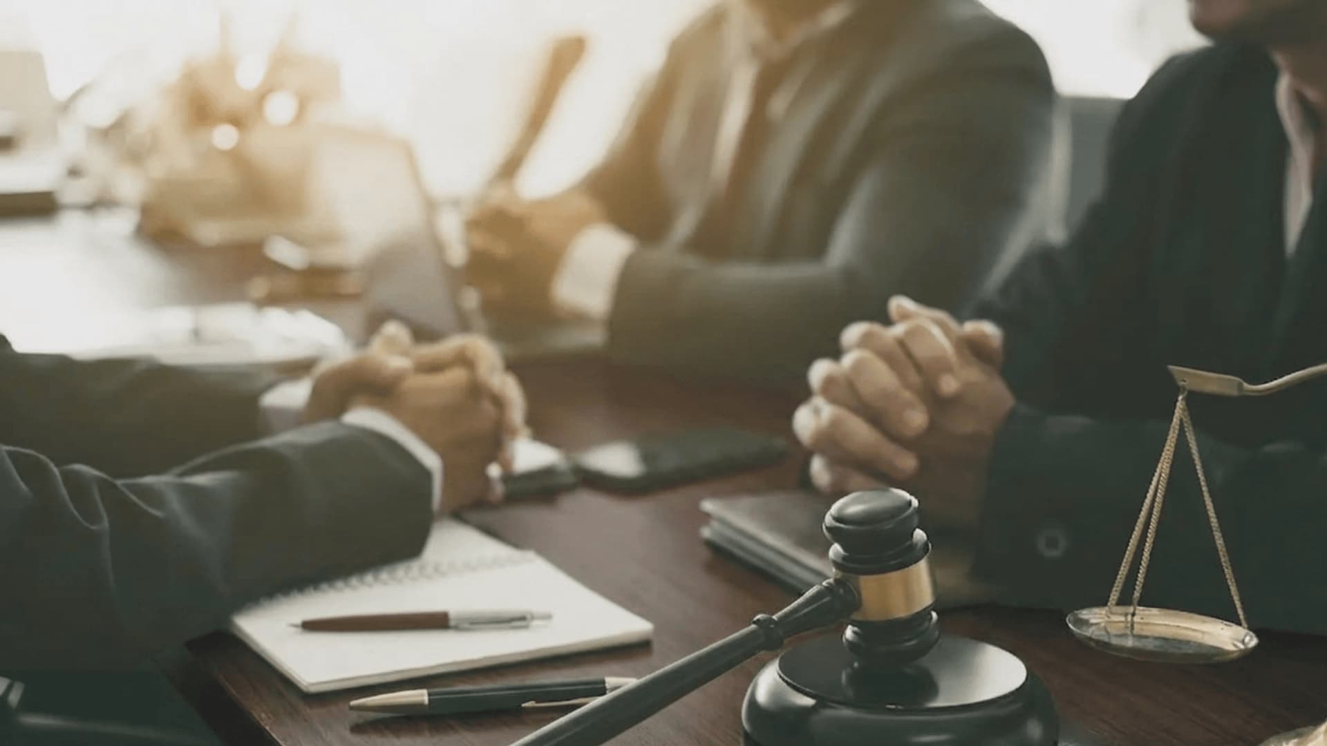 Lawyers at a deposition meeting with a gavel