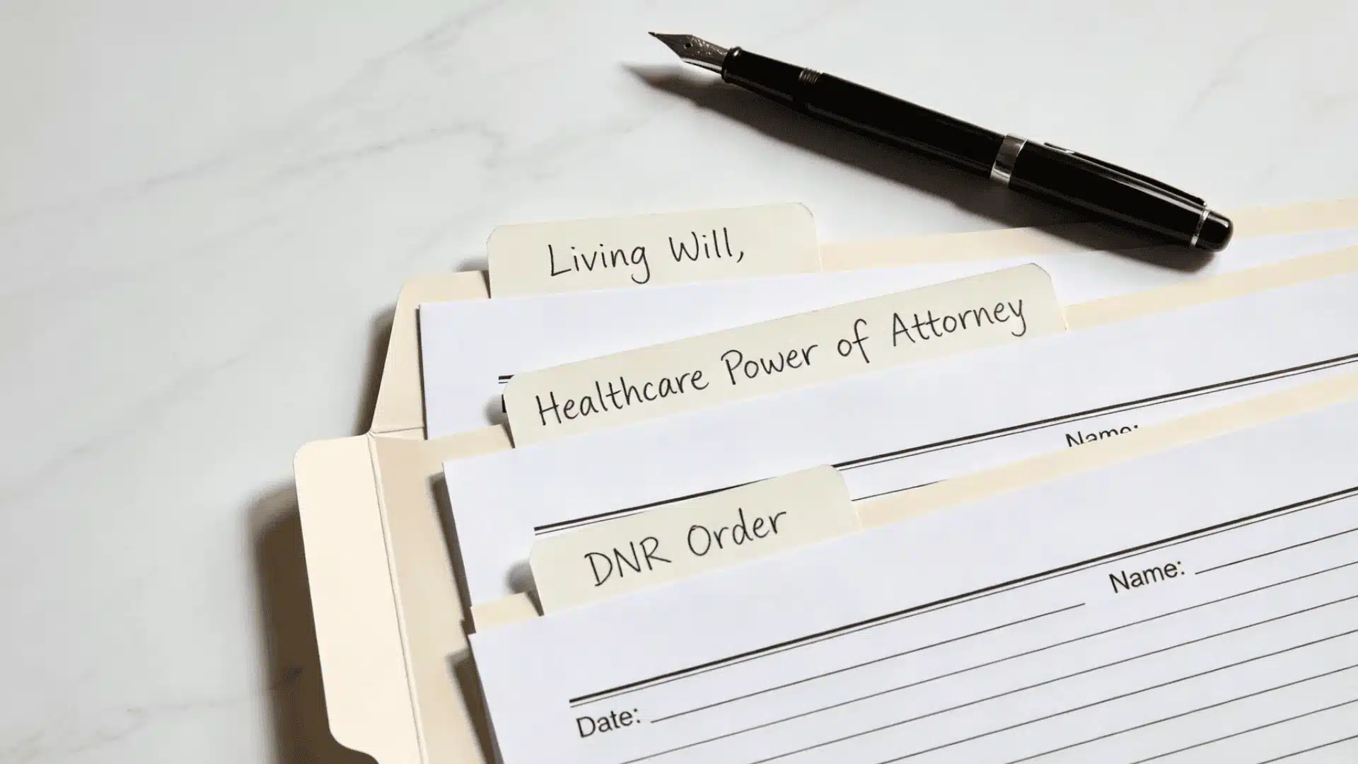 Legal documents including a living will, healthcare power of attorney, and DNR order arranged on a flat surface