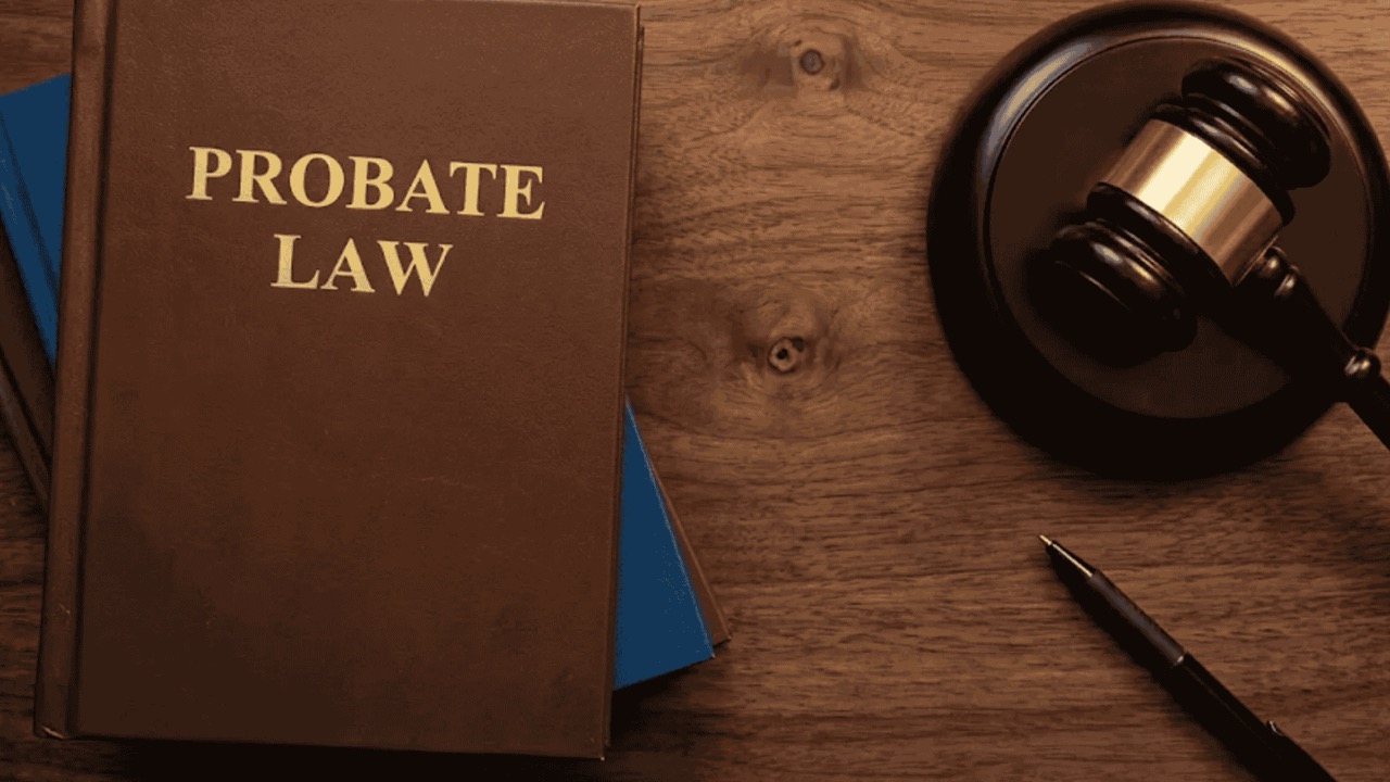 Probate law book with gavel and pen on wooden desk, symbolizing wills, and legal proceedings - 9