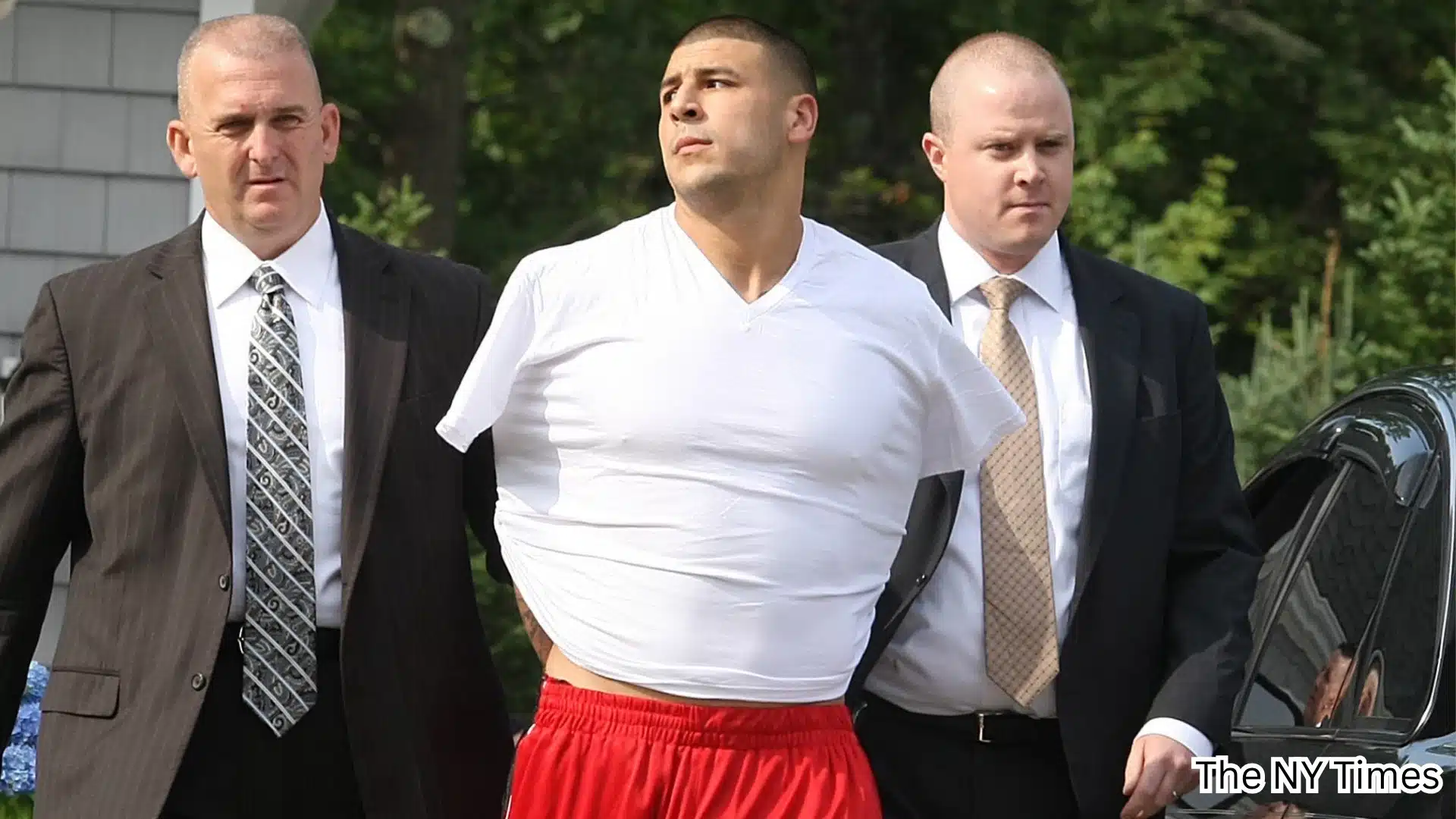 Aaron Hernandez escorted by two officers during proceedings connected to the Odin Lloyd murder case