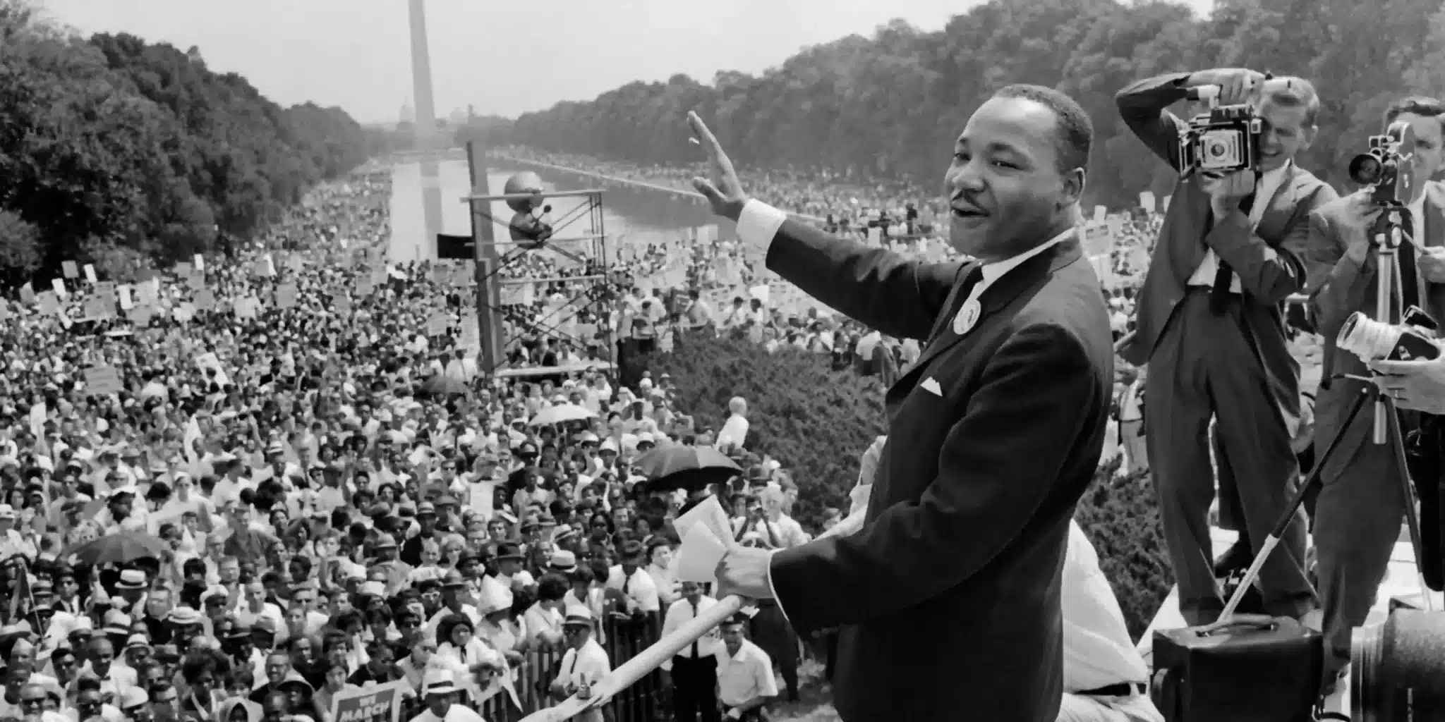 Civil rights leader waves to massive crowds at the 1963 March on Washington for Jobs and Freedom