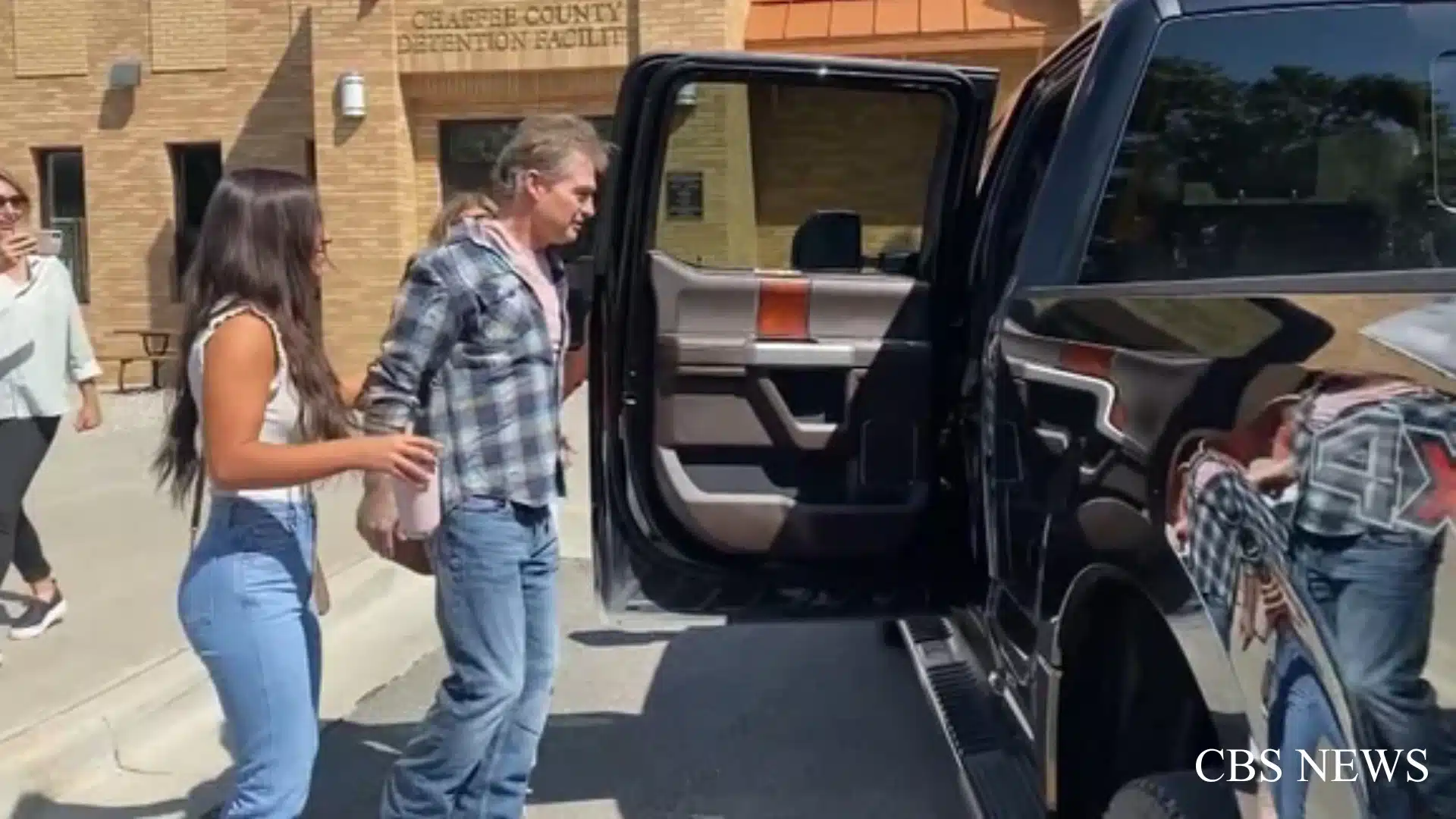 Barry Morphew escorted outside Chaffee County Detention Facility toward a pickup truck.