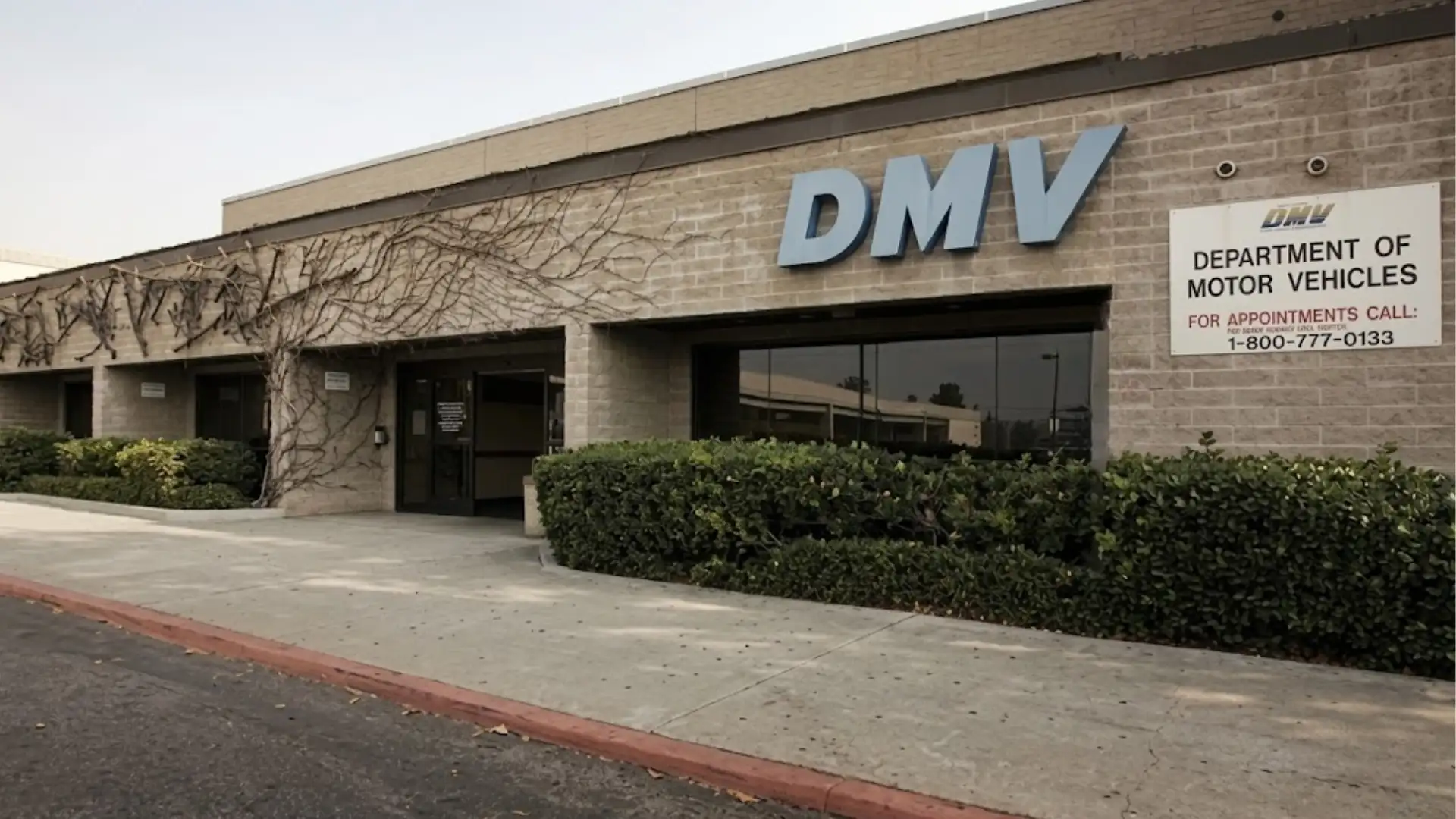 DMV building exterior with signage and entrance, showing government office location and parking area
