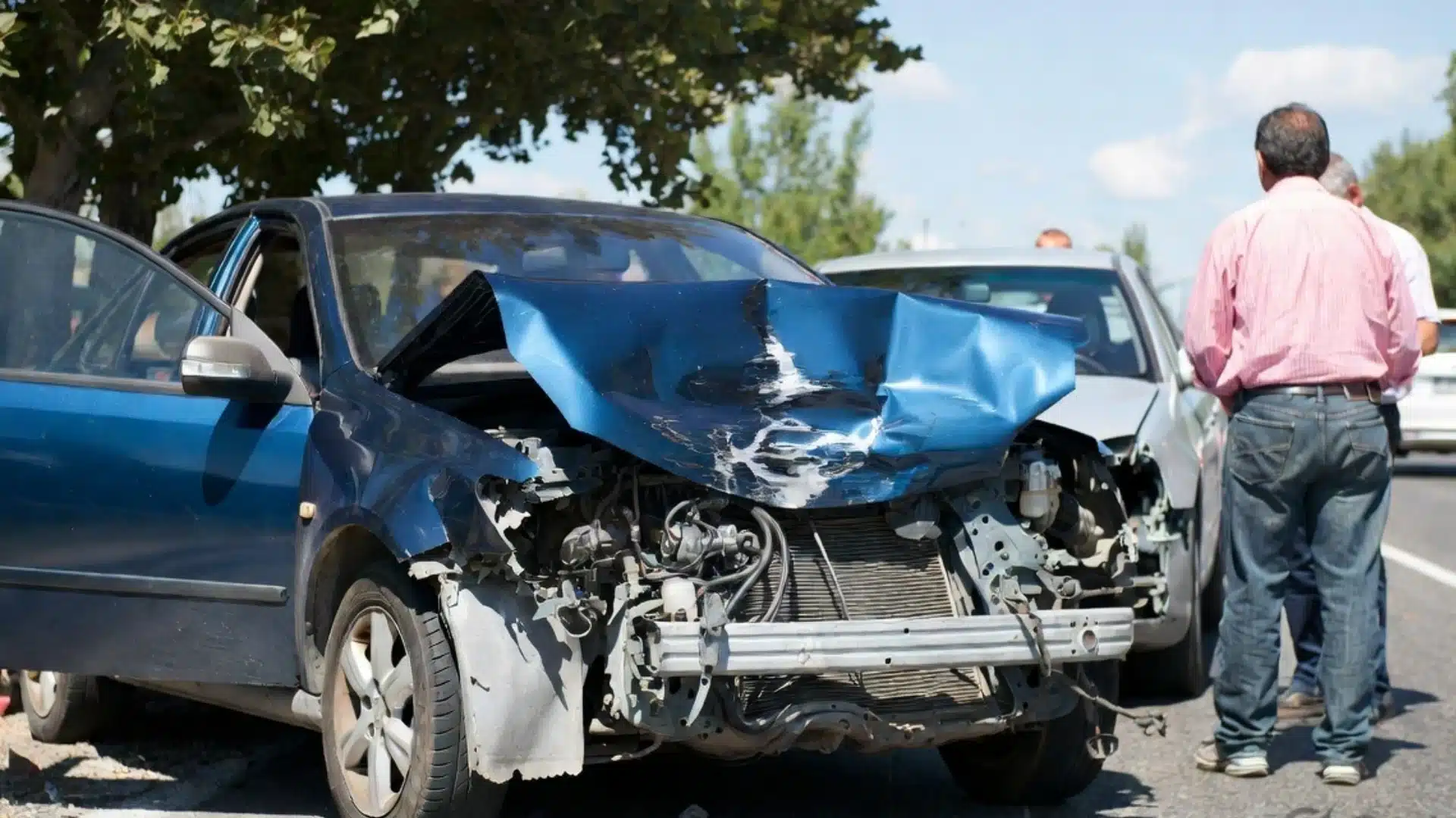 Damaged cars after Nevada traffic accident with injured drivers discussing insurance and legal claims