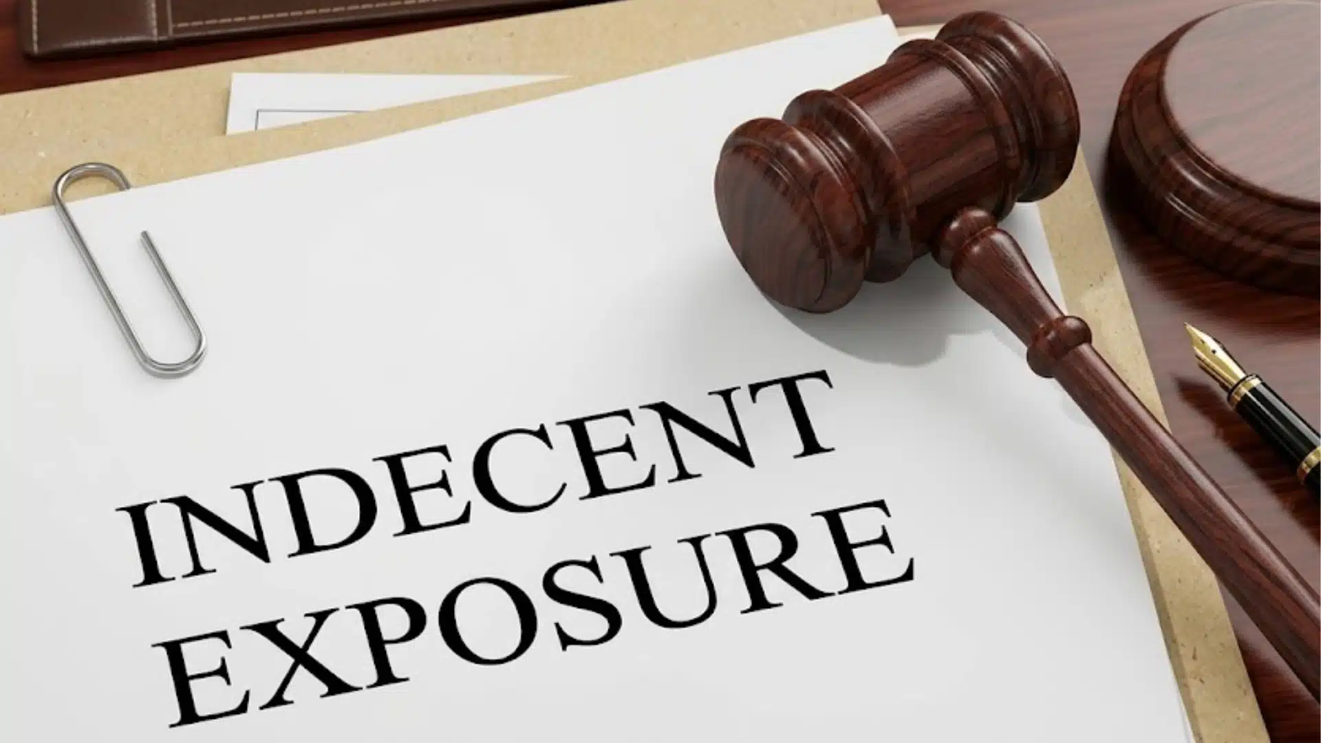 Indecent exposure legal document on a desk with a wooden gavel and court paperwork beside it