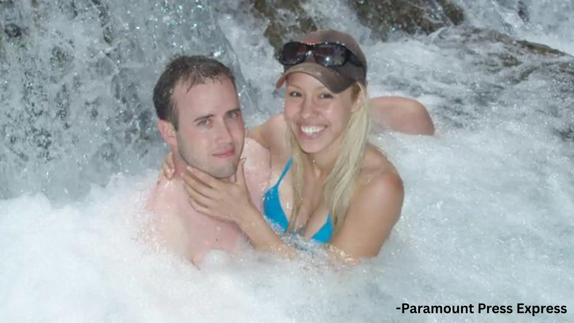 Jodi Arias and Travis Alexander posing together in a waterfall pool during a vacation outing