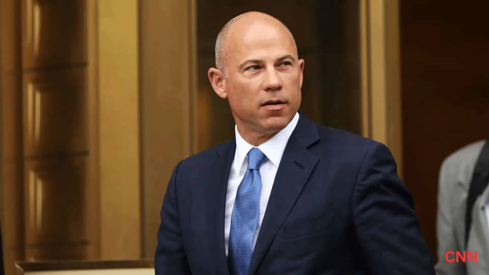 Michael Avenatti leaving court in a blue suit during a widely covered legal case