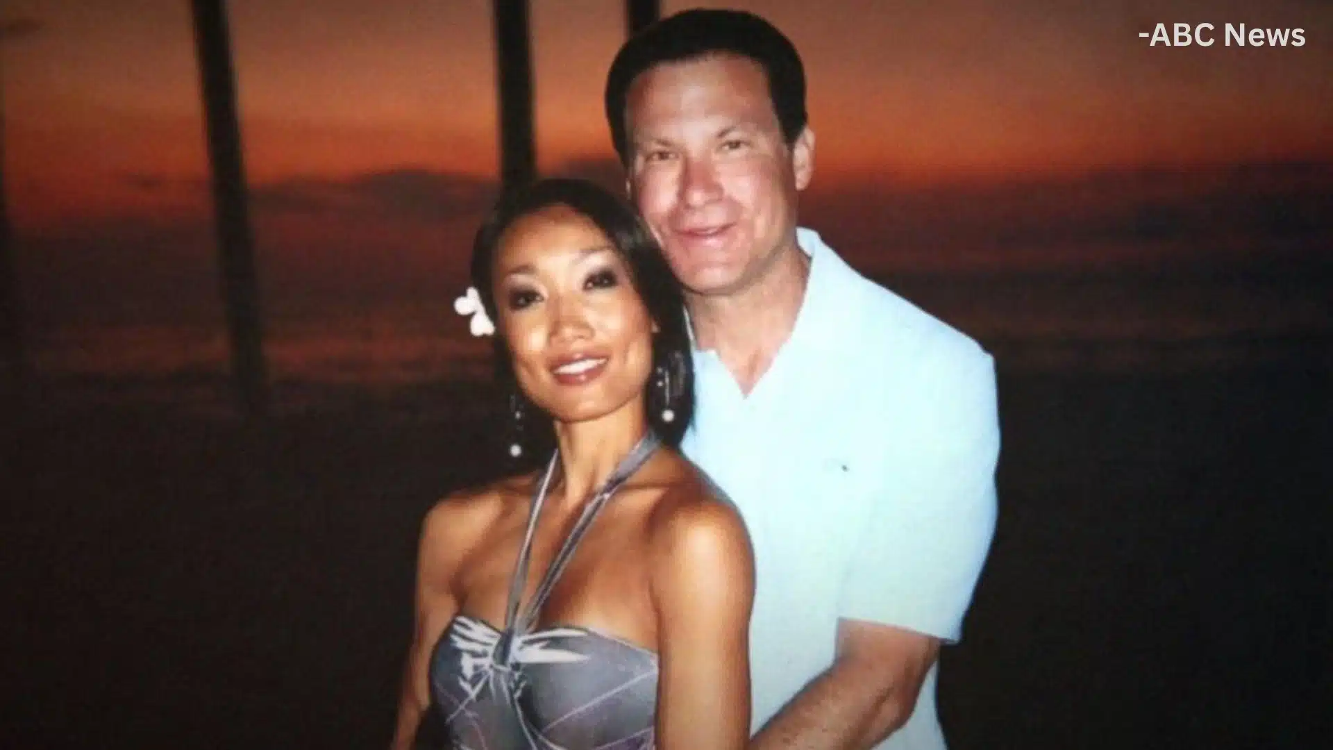 Rebecca Zahau posing with Jonah Shacknai outdoors at sunset near the water during an evening event