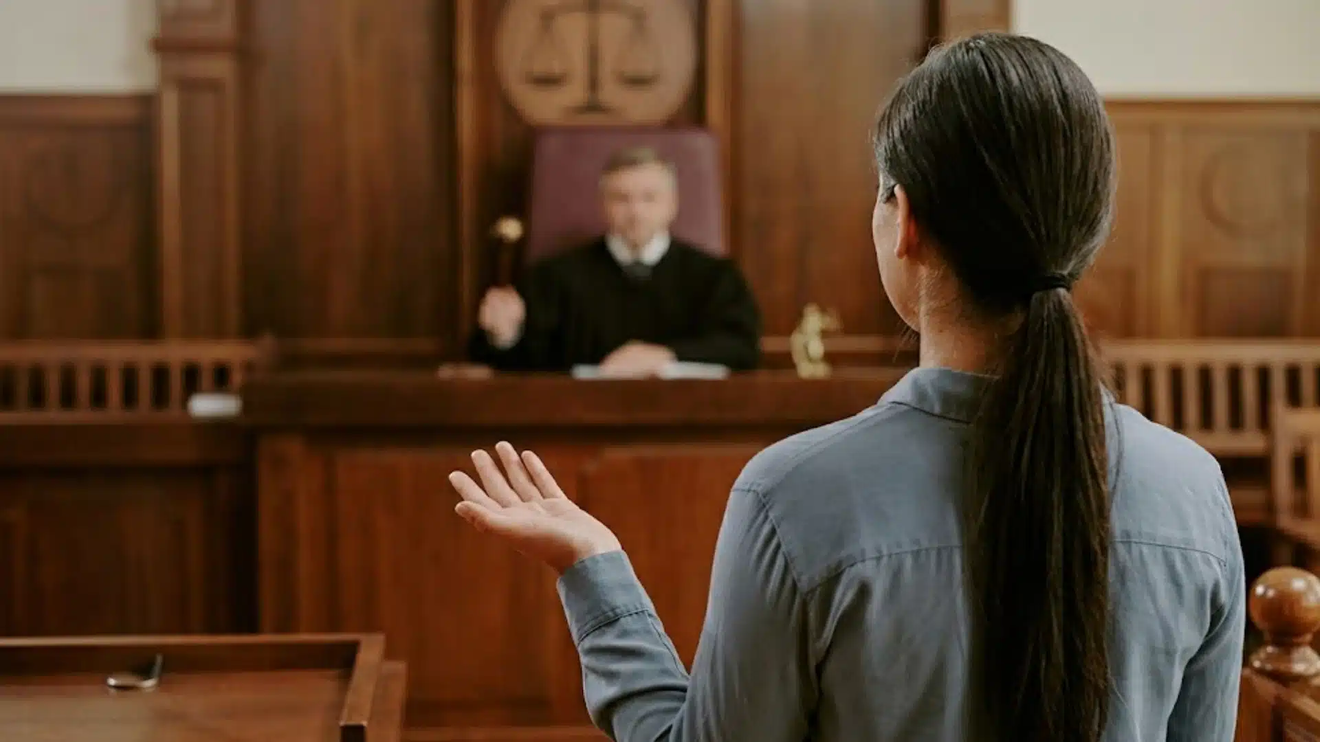 Woman speaking before a judge in court during a legal hearing about a failure to appear case