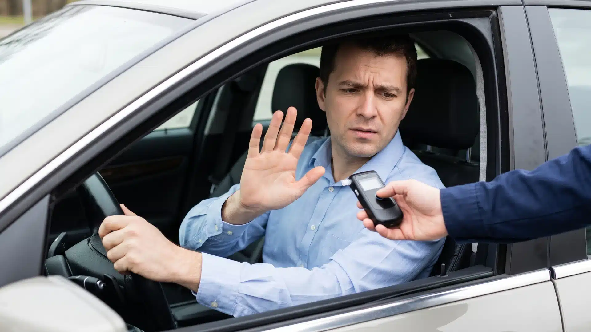 Driver refusing a breathalyzer test during a roadside traffic stop.